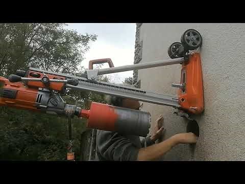 Core drilling a150mm hole through a 62cm solid stone wall. Carotteuse.