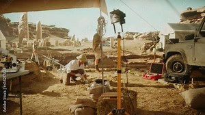 Archaeological Digging Site: Great Female Archeologist Work on Excavation Site, Carefully Cleaning with Brushes and Tools Newly Discovered Ancient Civilization Cultural Artifacts, Fossil Remains