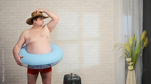 Funny adult man preparing for vacation on a resort. male presents himself on the beach.