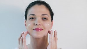 Young woman applying skin care cream on face - Free Stock Video