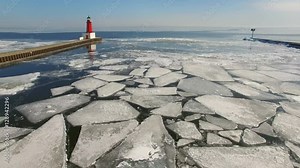 Scenic Winter aerial of Menominee North Pier Lighthouse. This lighthouse marks the mouth of the Menominee River between Marinette Wisconsin and Menominee Michigan.