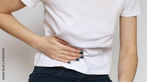 Girl sitting and holding her stomach, acute abdominal pain, abdominal pain