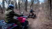 Extreme vacation in the woods on the ATV. Men engage in motor sport,...