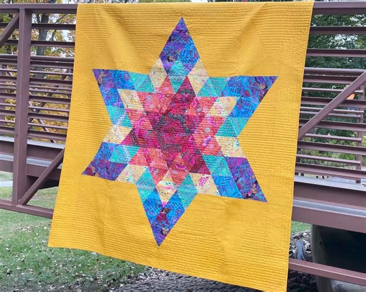 Our second featured rainbow quilt is Refraction! This stunning star quilt uses one strip roll, goes together quickly, and gives you lots of negative space for quilting adventures! Get the pattern: https://shop.quiltaddictsanonymous.com/product/refraction-pdf-pattern-download/ | Quilt Addicts Anonymous | Facebook