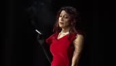 Drag queen smoking during theater performance