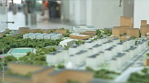 Miniature model of residential district with park in city on display in exhibition hall closeup. Architectural solutions