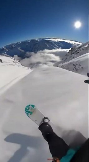 Snowboarder Takes Flight Off Mountain Cliff