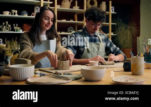 Happy woman man in pottery workshop creating handmade clay modeling class teacher student craft hobby sculpture couple date family potter artisan handcrafting ceramics have fun laughing in art studio Stock Video Footage - Alamy
