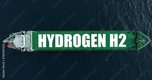 A large green ship in the blue ocean is carrying important cargo. The tanker uses hydrogen energy. Renewable energy for cargo transportation. Clean energy in the ocean
