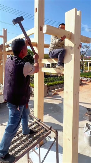 Carpenters Assemble Wooden Frame Using Traditional Joinery Techniques