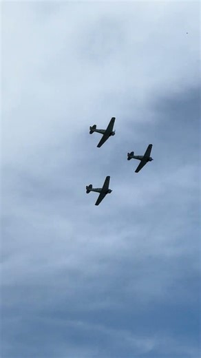 3 Beautiful classic military P-51 Mustangs (I think) flying over Orange County California. Planes