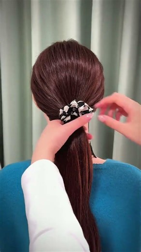 A stylish and fluffy bun hairstyle that can be achieved with just one rubber band Even