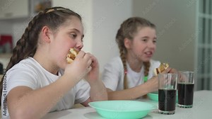 Children at table cafe indulge in fast food enjoying quick snacks. Children fast food party cafe lively chatter while eating. cafe becomes haven for children fast food tables are filled with laughter.