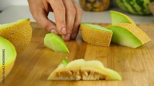 Precision slicing is used to take the hard skin off of galia melon chunks.