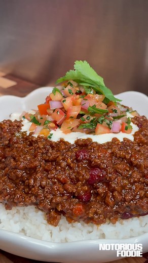 Chili Con Carne. The most comforting meat sauce, served with a fresh pico de gallo. A proper chili con carne should be bold, rich, and deeply satisfying. This version layers smokey spice, slow-cooked beef, and just the right amount of heat, all bound together by a thick, glossy sauce built from scratch. It’s a recipe that rewards patience and process: toasting dried chillies and making your own chilli paste, caramelising your beef properly, deglazing with beer and letting everything simmer until