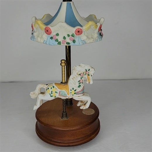 Kincaid's Kool Stuff on Instagram: "Carousel Collections Music Box Vintage Animated Horse Porcelain Floral Memories Relive the magic of the carousel with this charming vintage animated music box by Carousel Collections. This beautifully detailed piece features a white porcelain horse adorned with pink roses and a yellow saddle blanket. It stands under a matching blue and white striped porcelain canopy with floral relief. As the music plays the classic song "Memories" (from the musical Cats), the