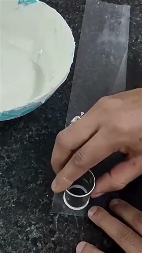 A food dough that is being poured using a special tool by a chef