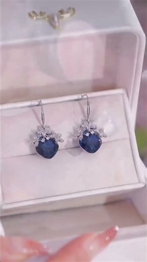 Deep royal blue heart gemstone surrounded by sparkling micro crystals.