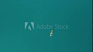 Top view of a family kayaking in blue sea. Unrecognizable woman, man and childrens. Kayak on turquoise sea water during warm summer vacation holidays at sea. Summer holiday vacation and travel concept