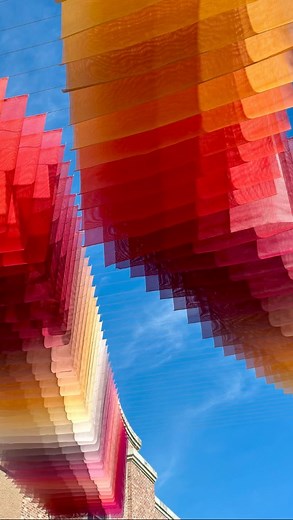 Above downtown Pensacola, waves of colour drift through the air, a living painting suspended between sky and street. Created by artist Tomislav Topic for Foo Foo Fest, Afterburn transforms the city’s skyline into a kinetic field of colour and light. Composed of painted mesh suspended between buildings, it drifts with the wind, catching light and shadow as if the air itself were painting in motion. Tomislav Topić is recognised for his bold, abstract explorations of colour, space and perception. D