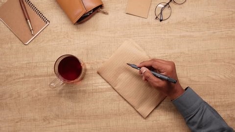 clip-3974453333-person-writes-2026-goals-on-paper-while