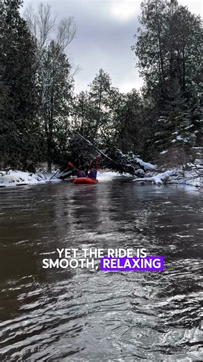 Drift down a crystal-clear river surrounded by snowy pines. ❄️ Guided, calm and oh-so-serene, winter rafting is a Michigan winter must-try! 💙 | Gaylord Michigan Tourism Bureau