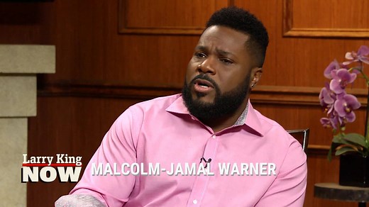 In this interview from 2017, Malcolm-Jamal Warner – who played Bill Cosby’s son, Theo Huxtable, on ‘The Cosby Show’ – opens up about the rape allegations against his on-screen father, and Malcolm’s relationship with him today. | Larry King