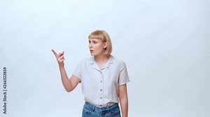 A young casually dressed woman with blue eyes and blonde hair is showing the emotion of being irritated and not satisfied. She is refusing an offer of selected MLM products.