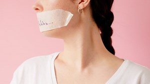 clip-1093217091-woman-turns-shows-her-mouth-taped-shut