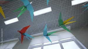 Ceiling with paper birds meticulously folded and suspended by invisible threads. Little birds crafted from vibrant sheets of paper
