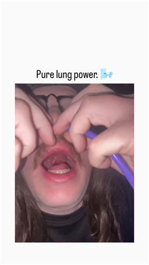 ViralSnap on Instagram: "- This 13-second video showcases a bizarre and impressive display of nasal control and lung capacity. - The Setup: A performer with long hair and a mustache begins by carefully threading two long, uninflated balloons—one red and one purple—up through his nostrils until they emerge from his open mouth. - The Connection: He pulls the ends of the balloons out of his mouth and attaches them to two large, air-filled balloon bulbs that he holds in his hands. - The Inflate: Wit