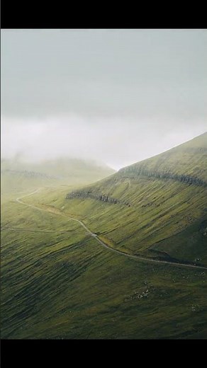 Gasadalur Faroe Islands: iconic Mulafossur waterfall dropping directly into ocean 4K