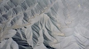 Mudstone formations of steel blue wavy sharp rocks ridges western Usa. Factory Butte canyon towering of wonder foothills. Aerial view over rugged terrain structure carved riverbed by erosion