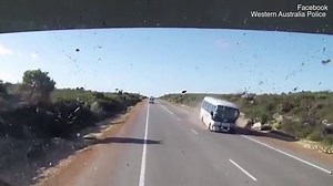 Horrific moment a car crashes head-on with a tour bus