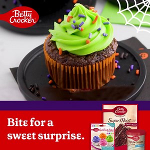 Bake up a spooky-sweet treat with these Surprise-Inside Halloween Candy Cupcakes 🍬🧁. Your little monsters will go wild! | Betty Crocker