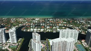 Beautiful Miami ocean front buildings with beautiful water view. Blue ocean with scenic clouds in the sky over the horizon line. Cinematic 4K arial of the coastal footage. Miami Beach, Florida USA.