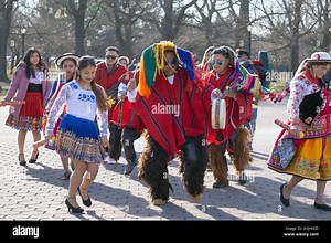 During a video shoot, a group of Ecuadorian dancers & musicians perform alongside the Unisphere in a park in Queens, New York City Stock Photo - Alamy