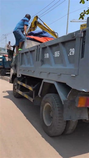 excavator digging earth dump truck