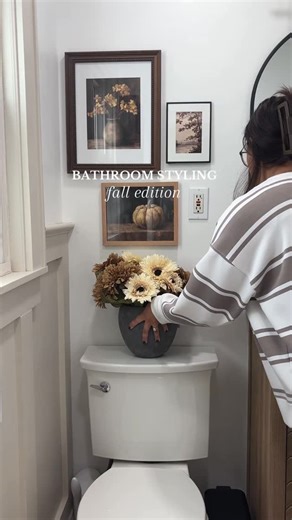 Sam ♡ | home & lifestyle on Instagram: "5 easy swaps to style your bathroom for fall 🍂 1. Kept the vase, switched to fall stems 2. Switched Etsy prints, kept my frames 3. A little fall candle 4. Fall scented hand soap 5. Brown floral shower curtain to tie it all in I keep it simple, just small seasonal switches so it feels festive without breaking the budget 🤎 Shop my bathroom on LTK- link in bio Neutral home, small bathroom, small bathroom inspo, fall bathroom, Etsy prints, fall