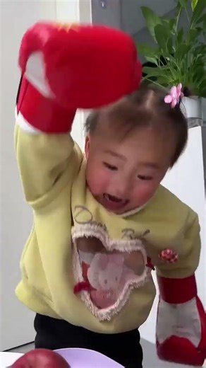 The little child helps his mother crush the apples!