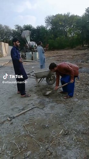Manual Labor on a Construction Site with Concrete Mixing