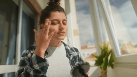 clip-4017305153-female-applicant-fixes-makeup-quickly-during-online