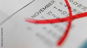 The month of November is crossed out on the calendar with a red marker. End of the month in the office. Macro.