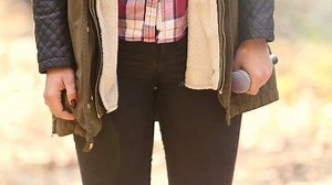 Close-up view of woman hands, snapping her fingers and holding a microphone, graded, in slow motion