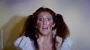 A scared woman dressed up like a little girl, screaming and running away from a danger we don't see. Funny comedic shot.