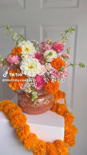 This Day of the Dead flower arrangement is created to commemorate and celebrate this traditional Mexican holiday. It features an assortment of vibrant flowers such as marigolds, dahlias, ranunculus, and and carnations, all carefully selected for their vibrant colors and symbolism. The rich colors, intricate details, and traditional symbols make it a heartfelt tribute to honor and remember loved ones who have passed away during this meaningful holiday. #flowers #floristoftiktok #flores #floristal