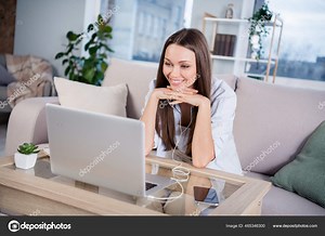 Photo of happy smiling beautiful cheerful smiling businesswoman sit sofa at home house watching video in laptop computer