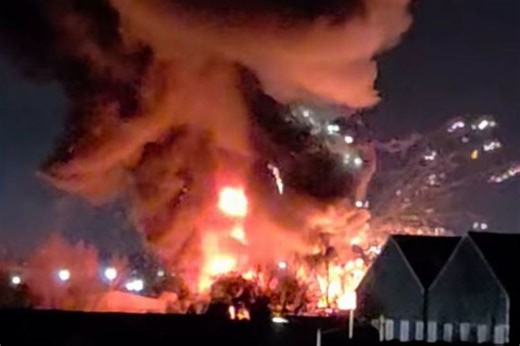 Dramatic moment explosion at unit 'full of fireworks' that forces a firefighter to flee
