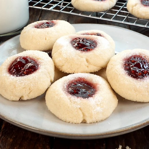 Recipe=>https://butteryourbiscuit.com/raspberry-thumbprint-cookies/ Raspberry Thumbprint Cookies are made with a buttery, crisp shortbread base and topped with a deliciously sweet raspberry jam for an outstanding texture and flavor combination. | Butter Your Biscuit