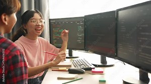 Slow motion back end software developer engineer for computer programming working together on debugging writing computing code, solving complex algorithms display on monitor in office. Burgeoning